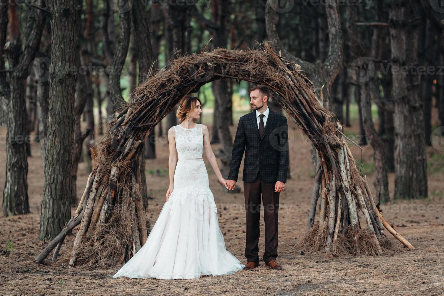 walk of the bride and groom through the autumn forest photo