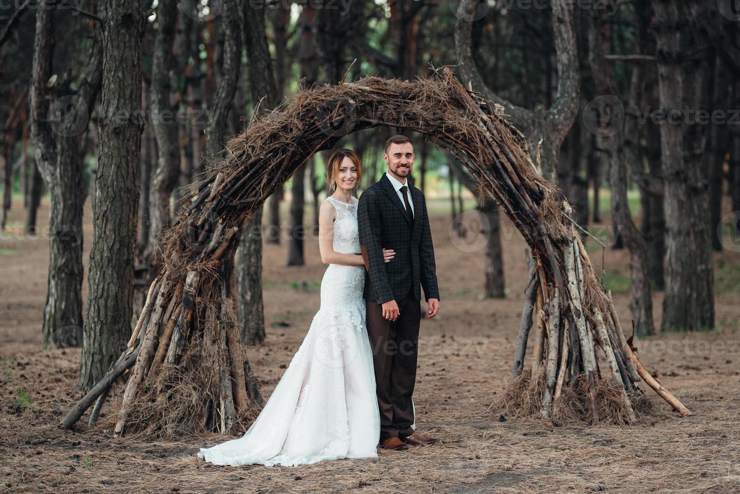 walk of the bride and groom through the autumn forest photo