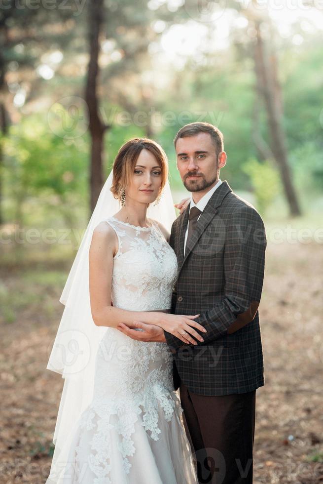 walk of the bride and groom through the autumn forest photo