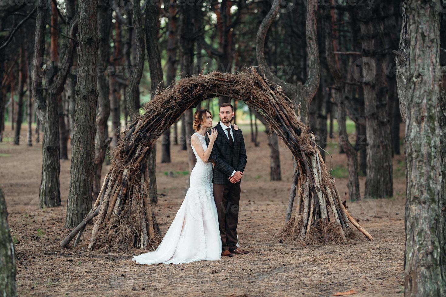 walk of the bride and groom through the autumn forest photo