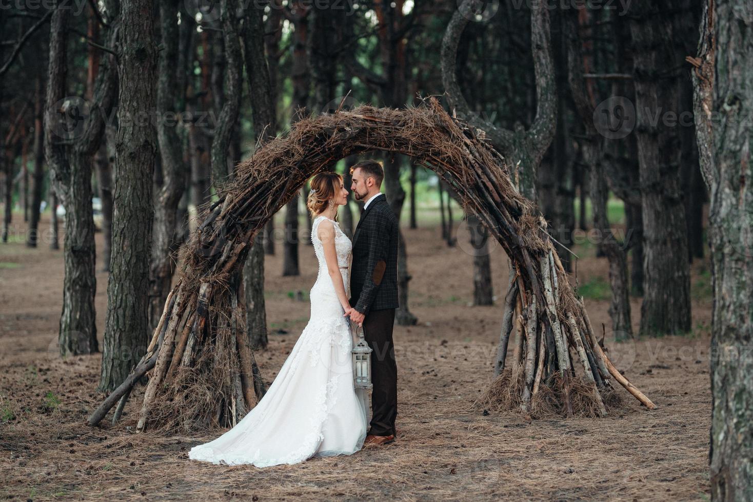 walk of the bride and groom through the autumn forest photo