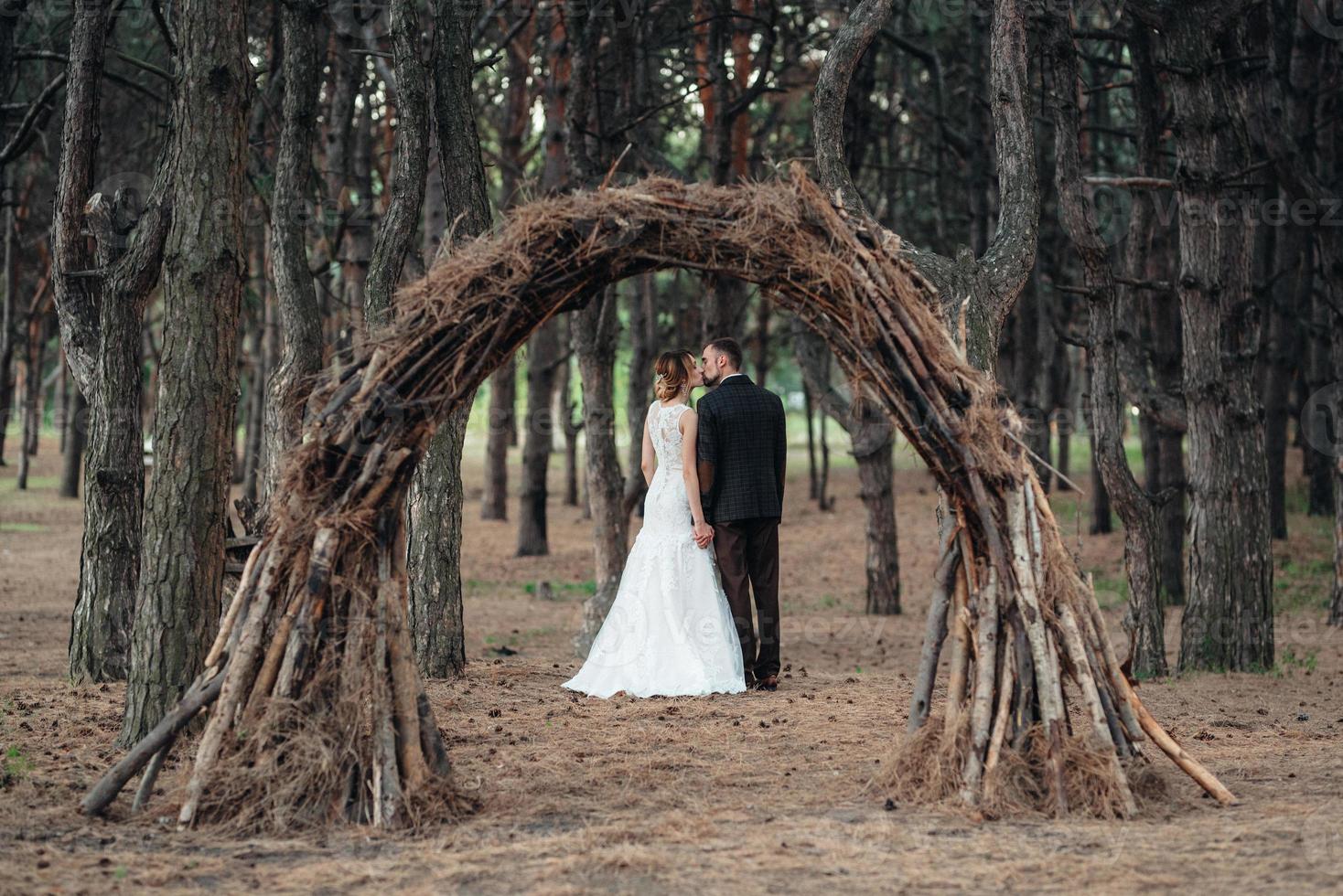 walk of the bride and groom through the autumn forest photo