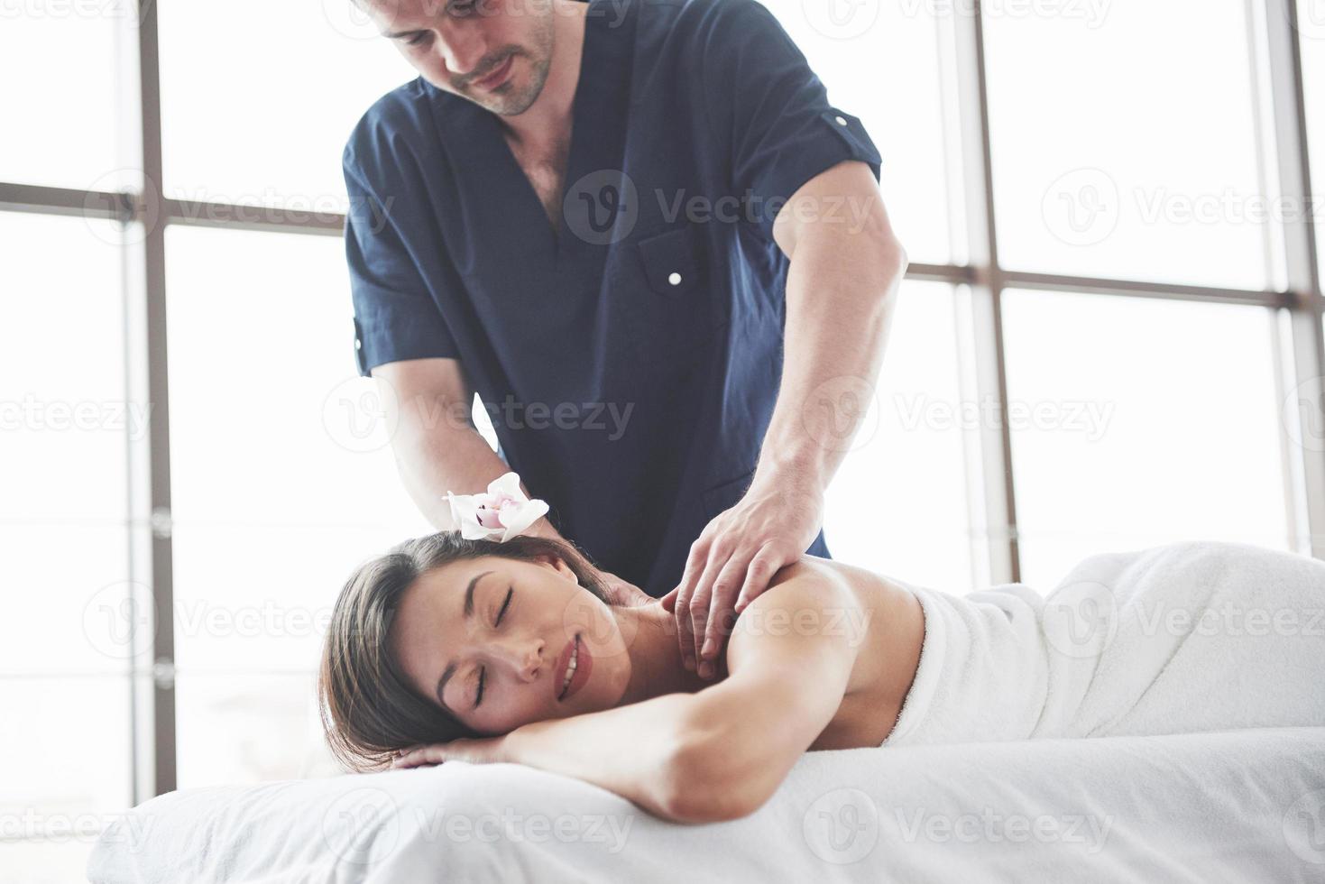 Young beautiful woman relaxing from the massage face photo