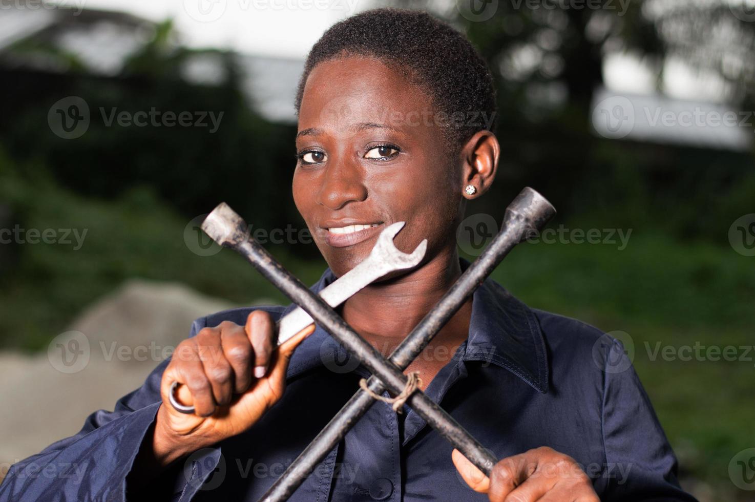 Young mechanic showing her tools photo