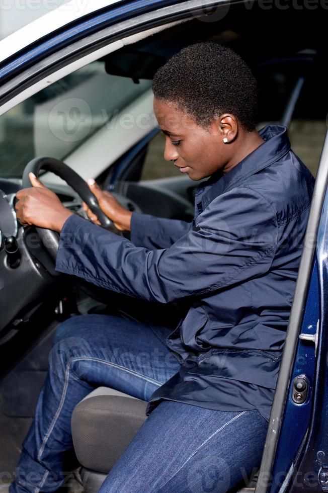 Young woman mechanic in a car. photo