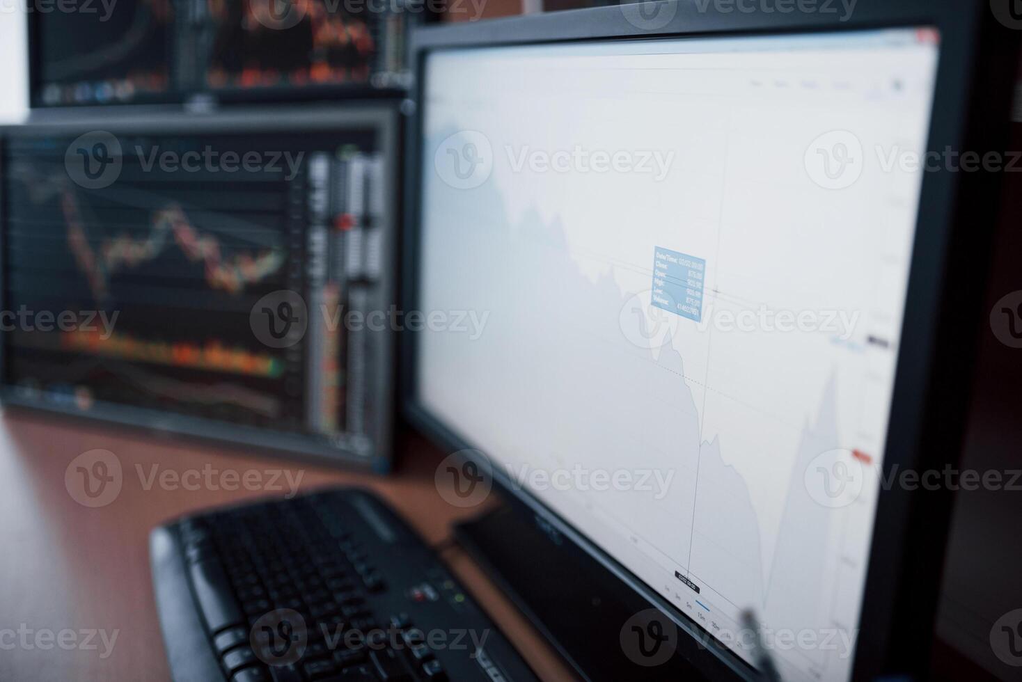 Analyzing data. Close-up of young businessman pointing on the data presented in the chart with pen while working in creative office photo