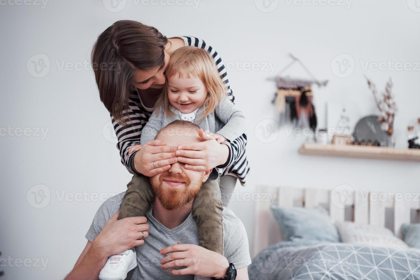 Happy family mother, father and child daughter at home photo