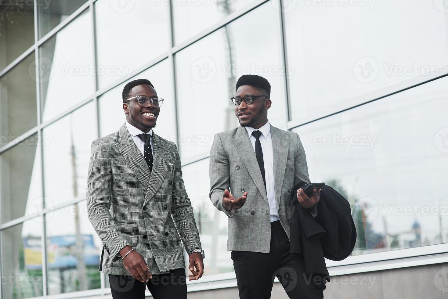 The image of two African American businessmen goes to a meeting in the office photo