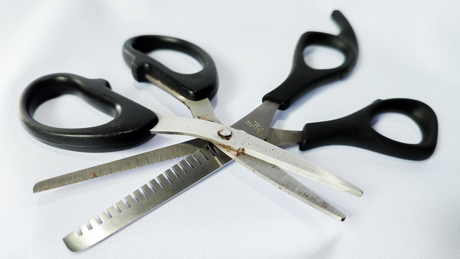 Two Scissors Black Color Handle isolated on white background photo