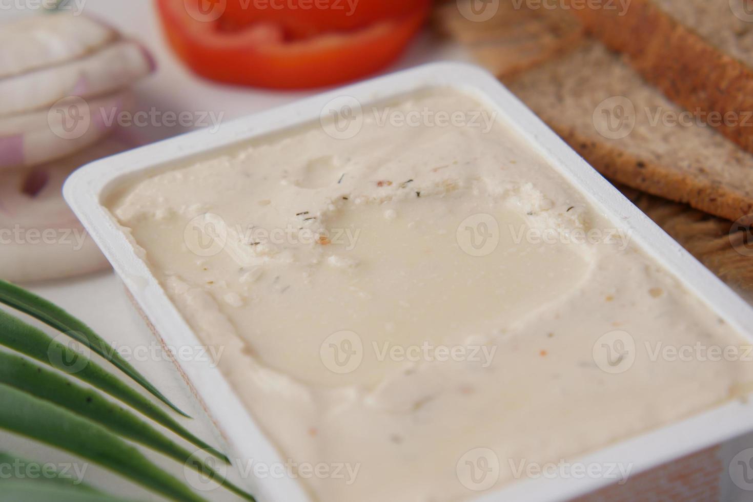 low fact cheese cream in a container on table, photo