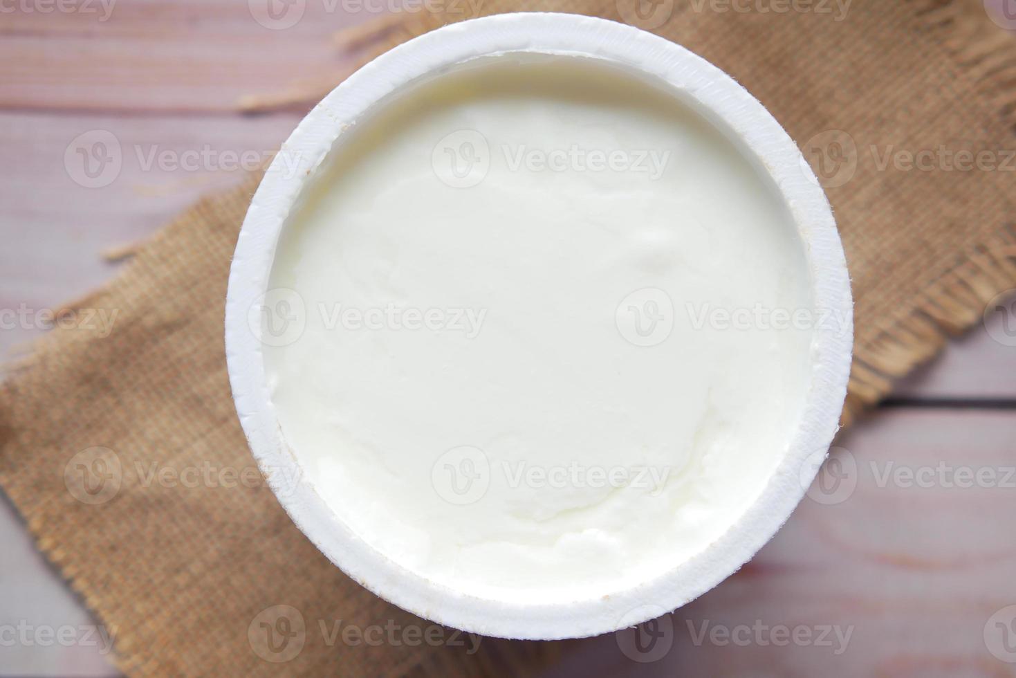 fresh yogurt in a bowl on table photo