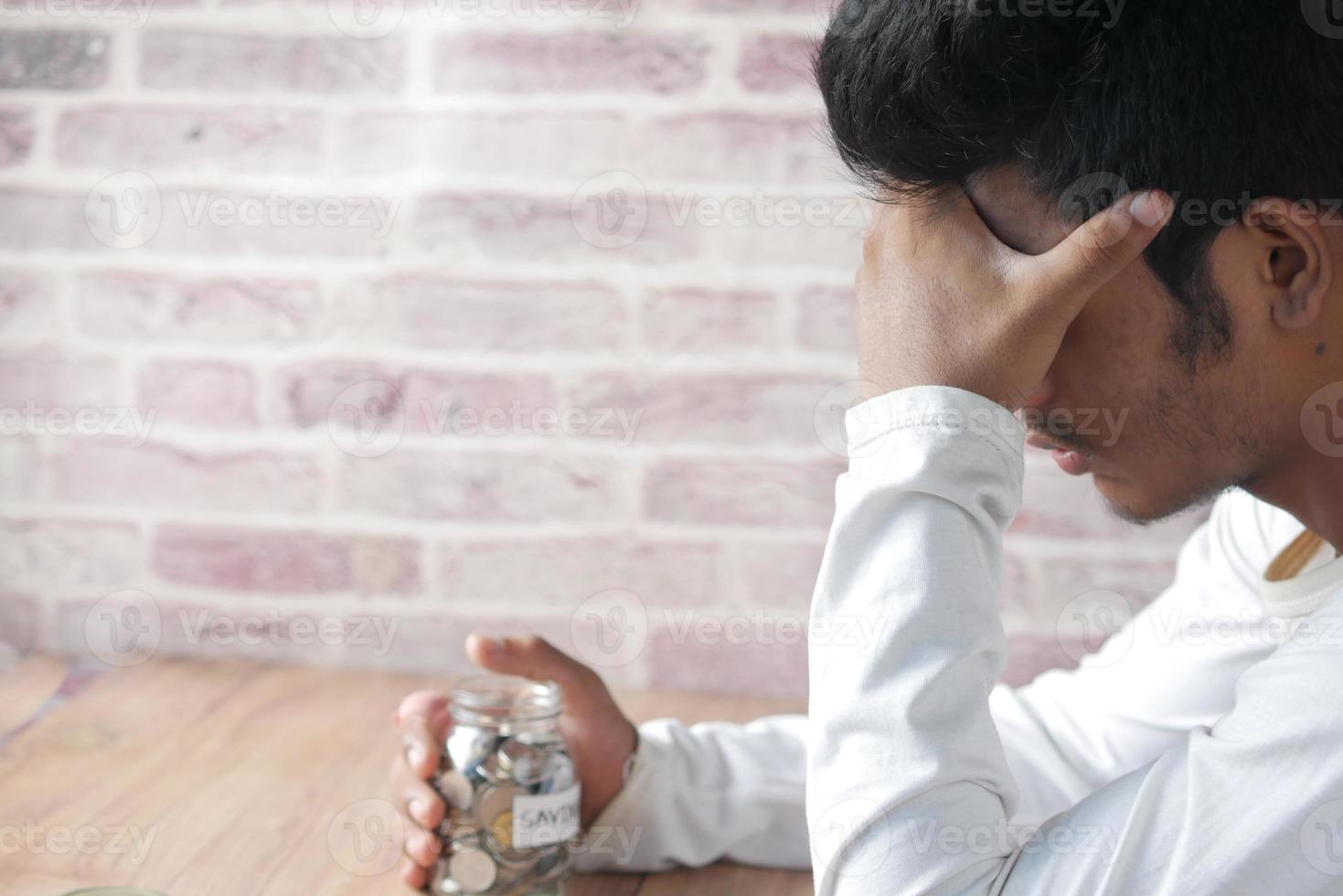 Depressed man feeling sick and worried about financial problem photo