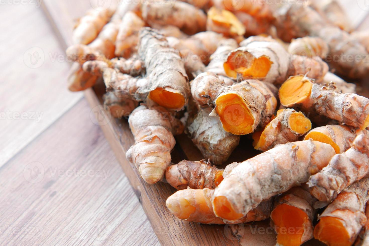 detail shot of turmeric root in a bowl on table photo