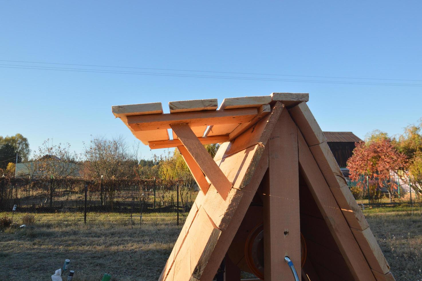 Wooden house for drinking water well photo