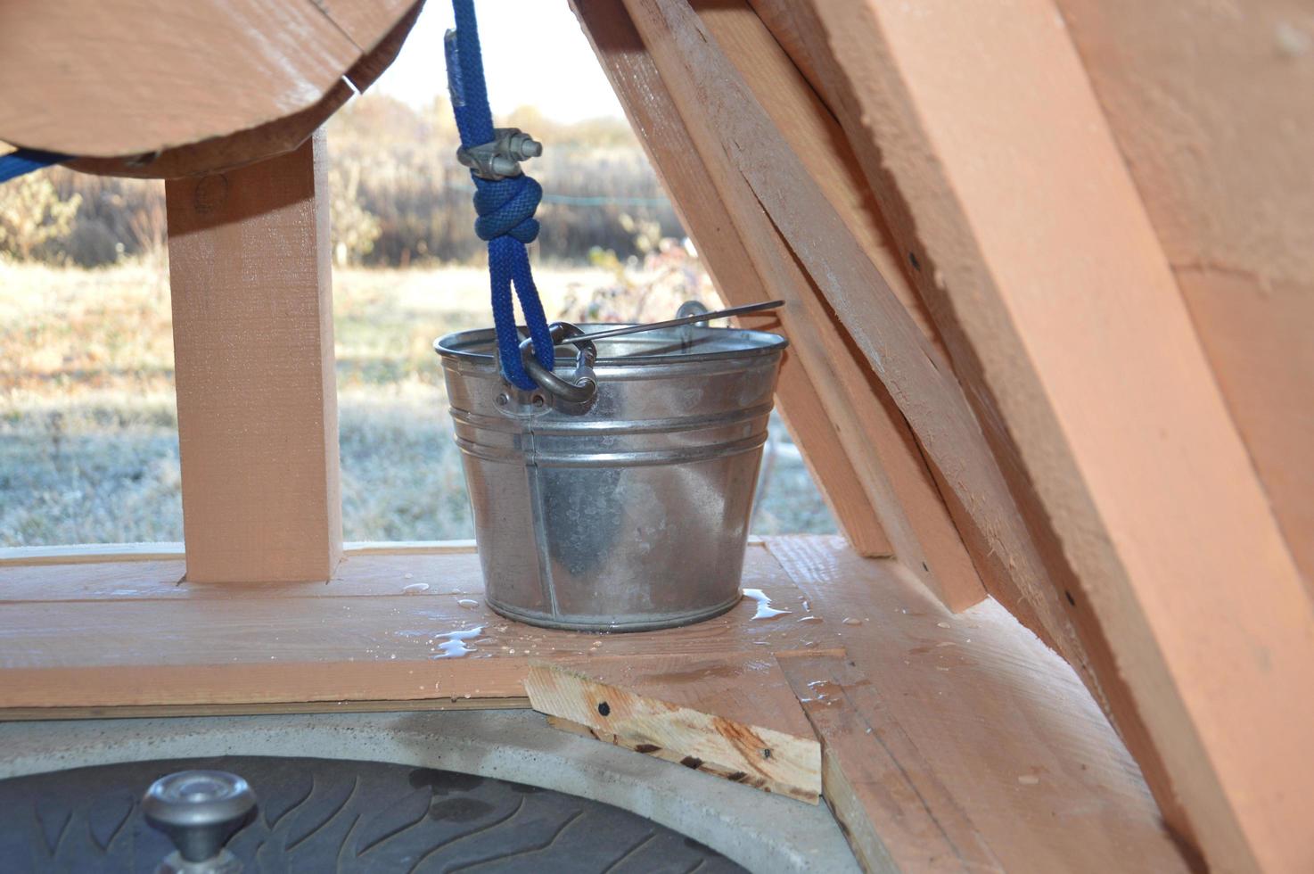 Wooden house for drinking water well photo