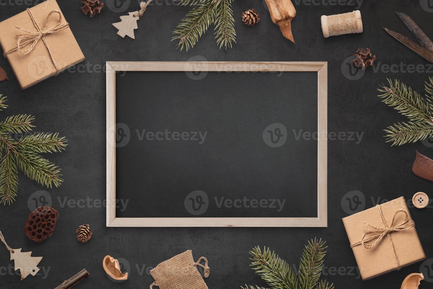 Chalkboard mockup surrounded by Christmas decorations. Empty board for greeting text photo