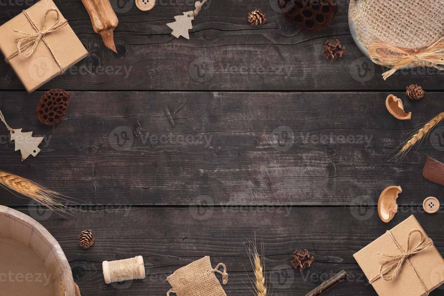 Rustic Christmas composition on wooden table. Free space in the middle for greeting text photo