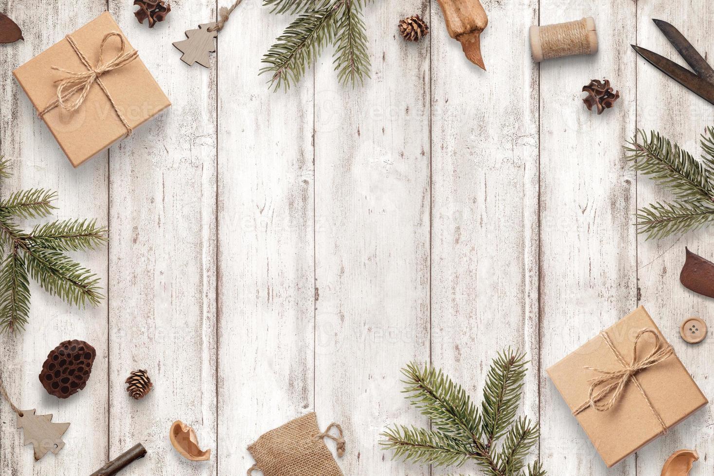 Rustic Christmas composition on white wooden table. Top view, flat lay scene with copy space in middle photo