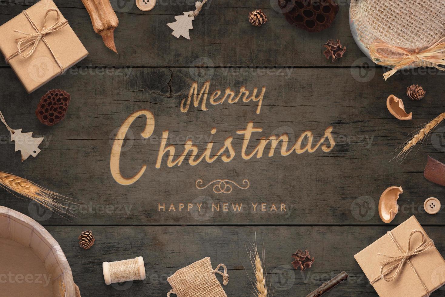 Merry Christmas and Happy New Year greeting card. Rustic top view composition. Carving handwork on wooden surface photo