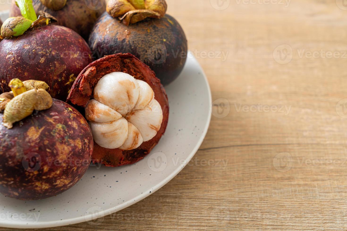 fresh mangosteen on white plate photo