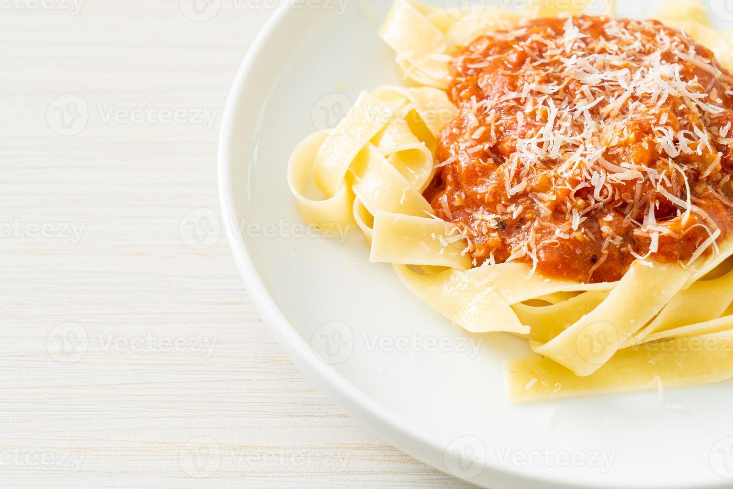 pork bolognese fettuccine pasta with parmesan cheese photo