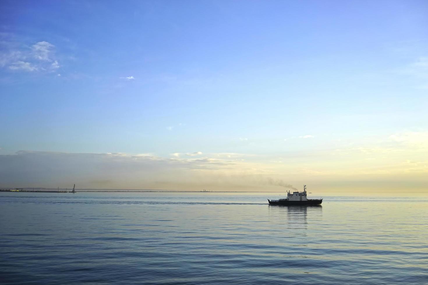 Seascape with a ship on the horizon photo