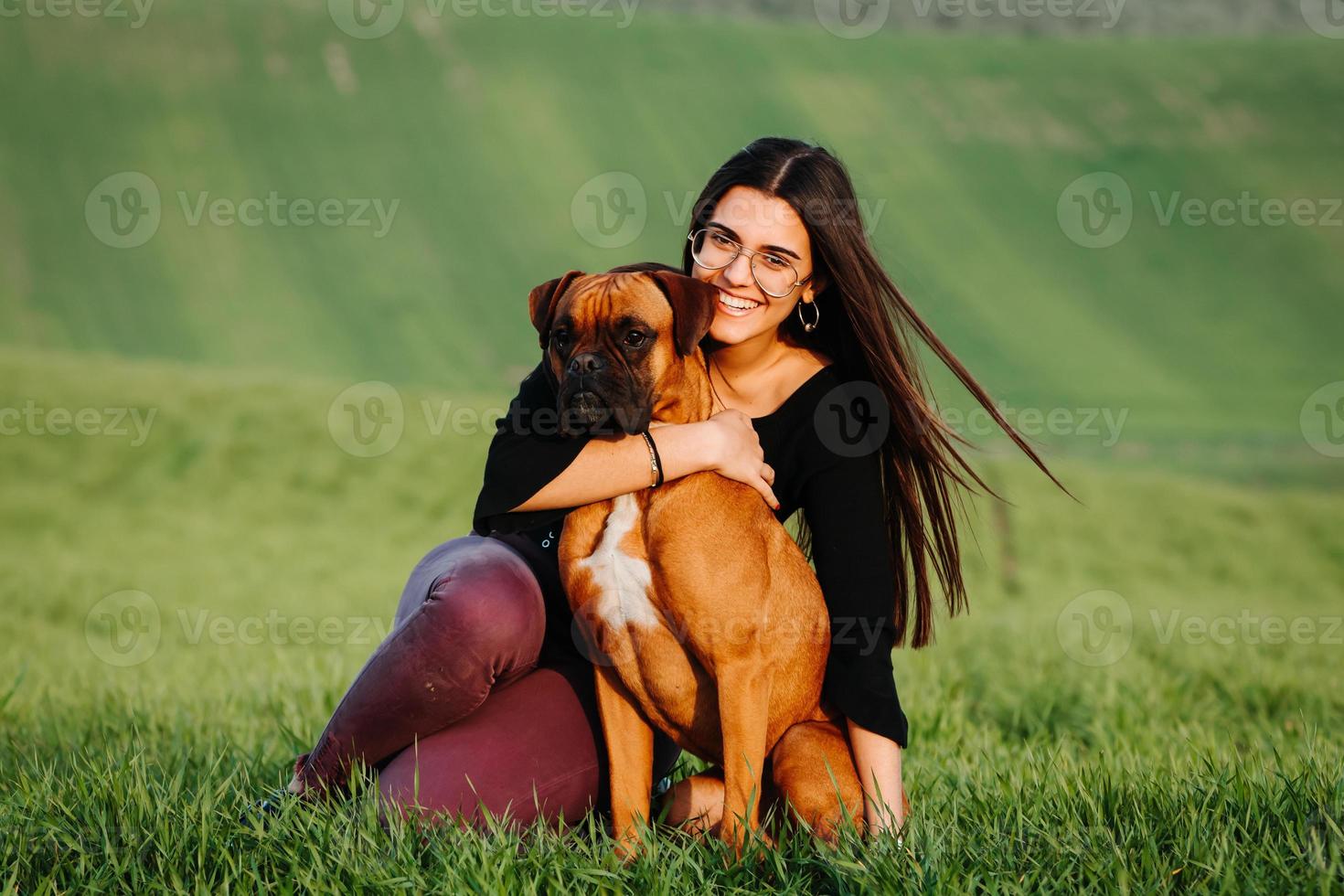 Beautiful woman playing with her dog. Outdoor portrait. photo