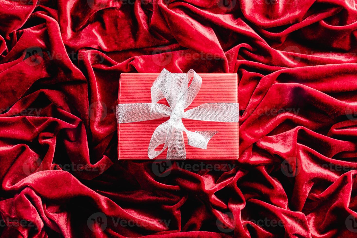 Gift on red velvet background. Christmas decoration photo