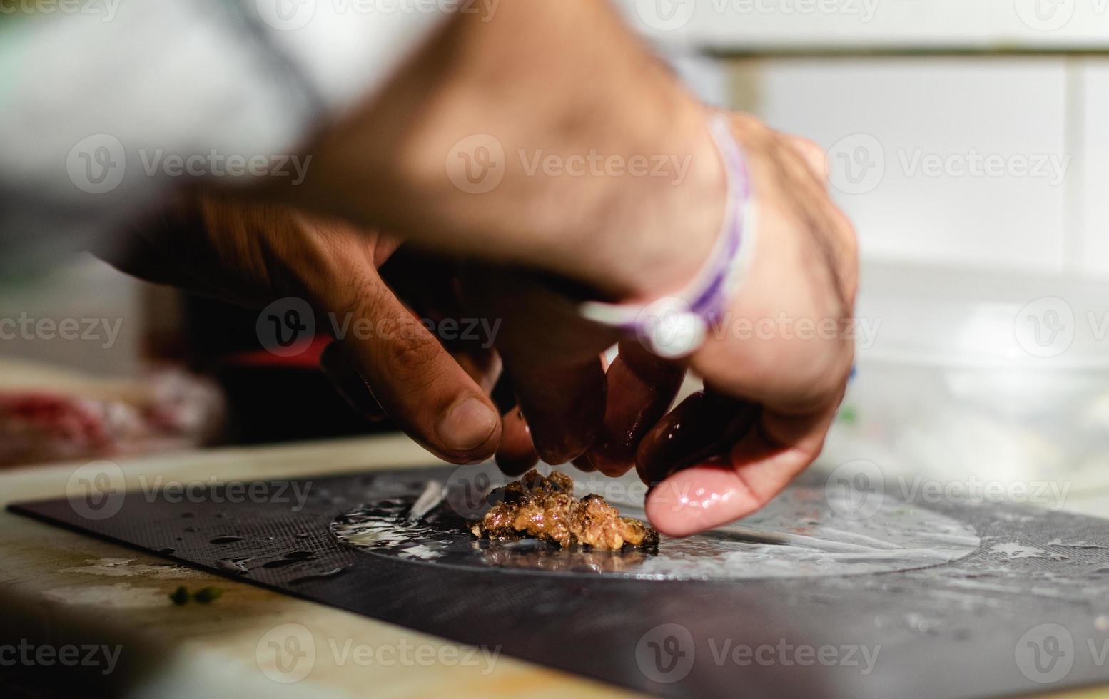Making Vietnamese traditional spring rolls by hands in a restaurant photo