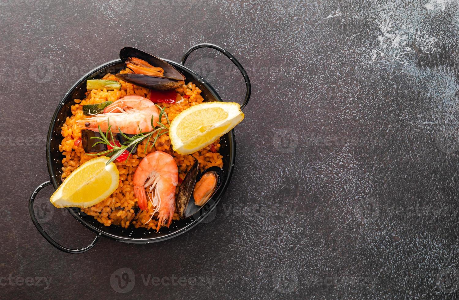 Vegetable paella with seafood, top view and copy space photo