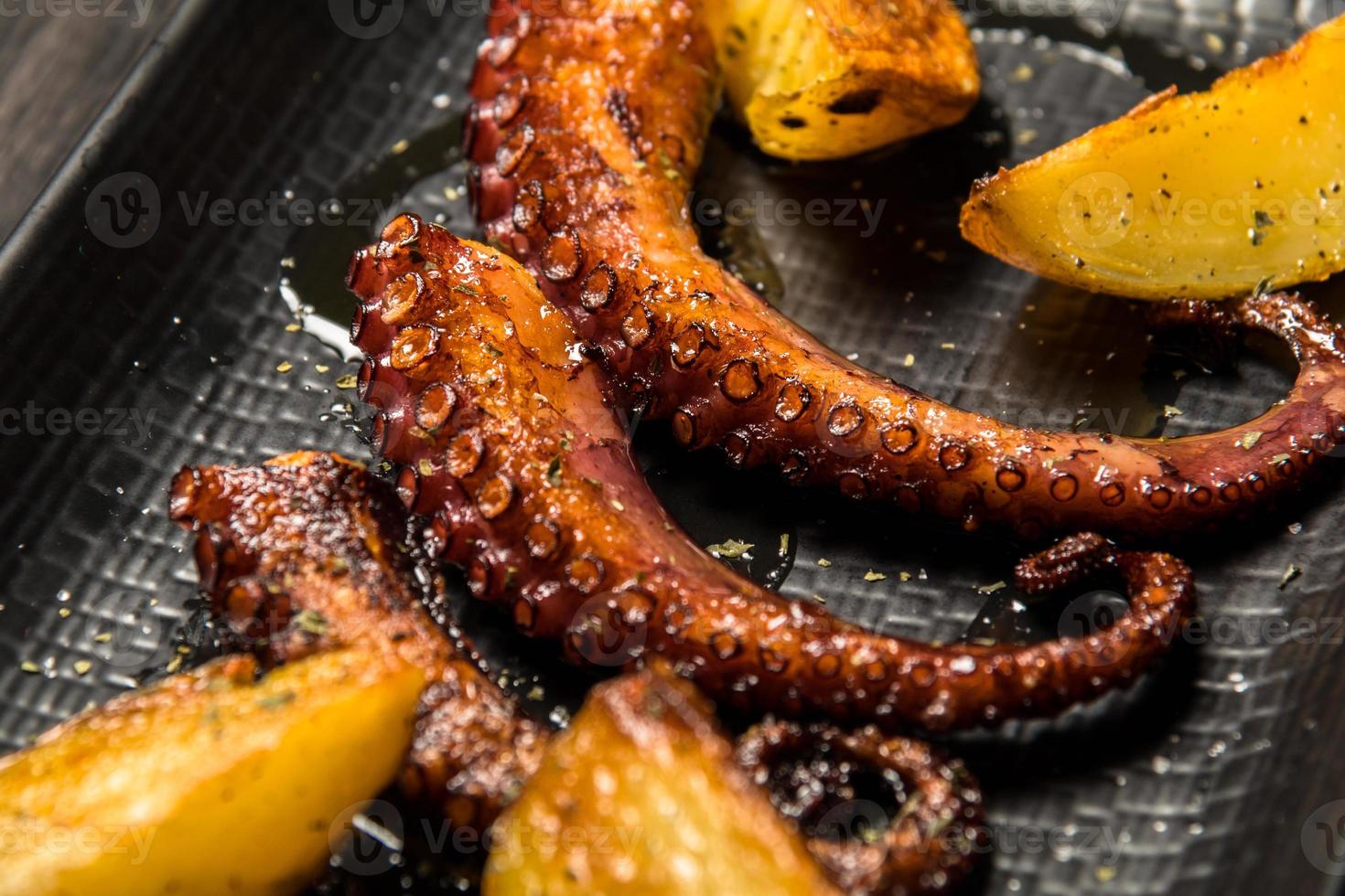 octopus tentacles grilled with potatoes photo