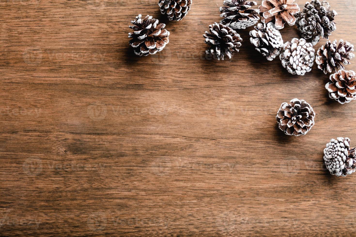 Pine cones on wood background. Christmas decoration with copy space photo