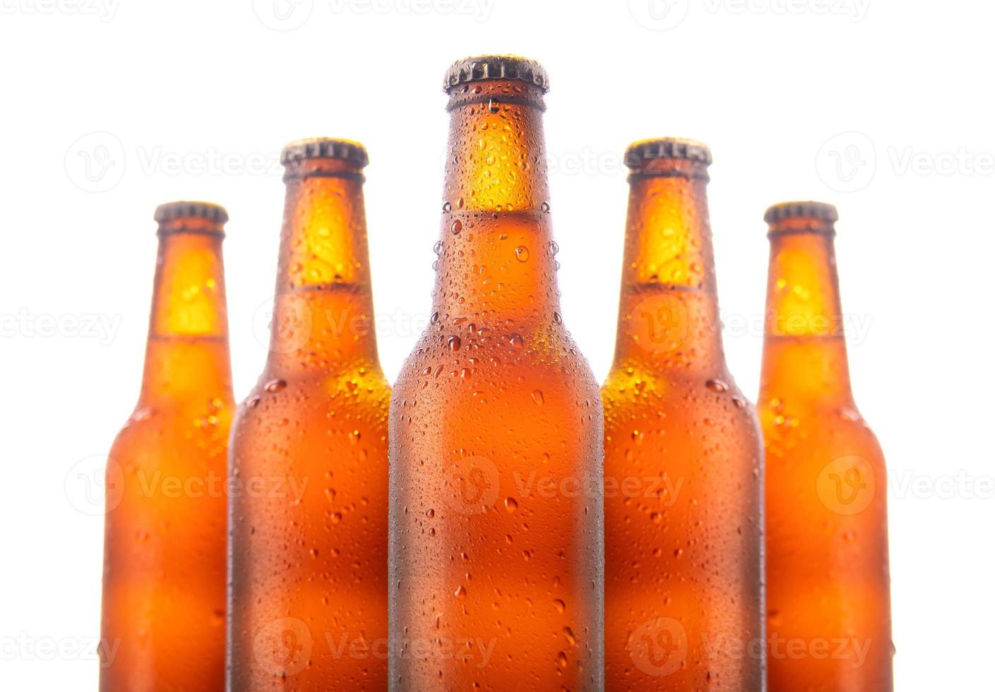 Set of five beer bottles isolated on white background photo