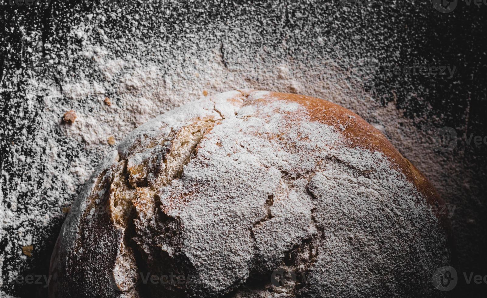 dark homemade bread dusted with flour photo