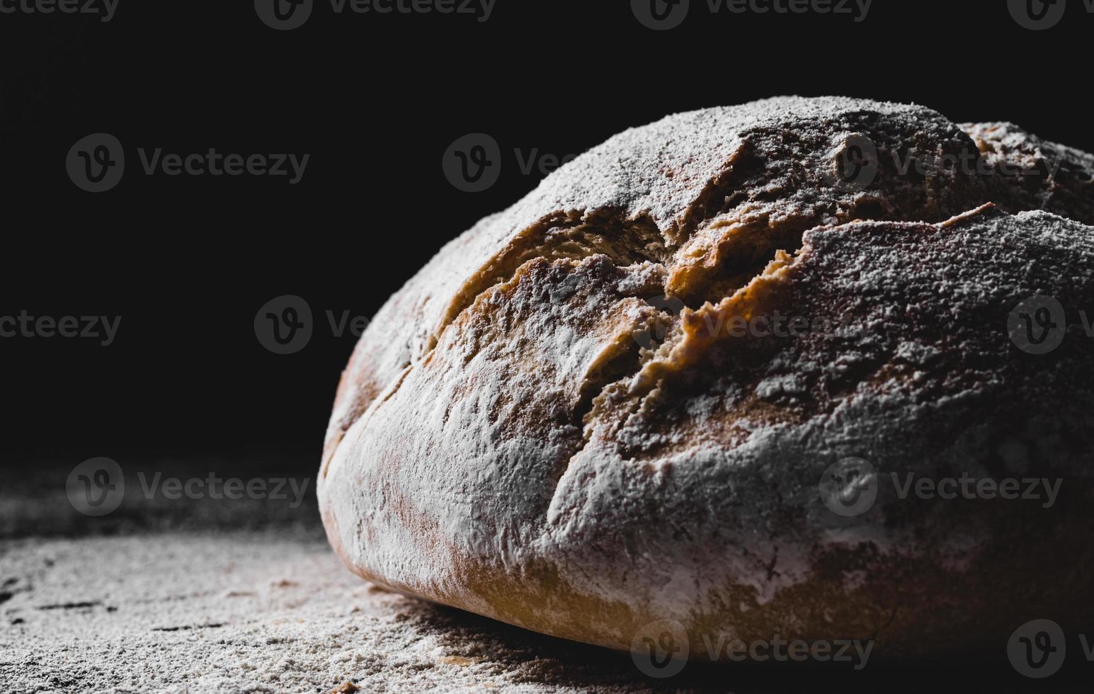 dark homemade bread dusted with flour photo