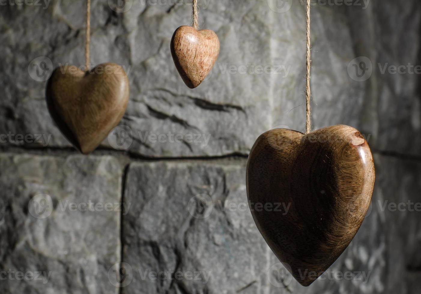 Wooden hearts and old stone wall photo