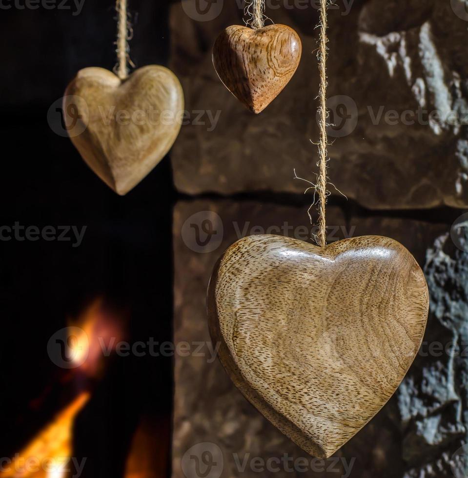 Wooden hearts and old stone fireplace photo