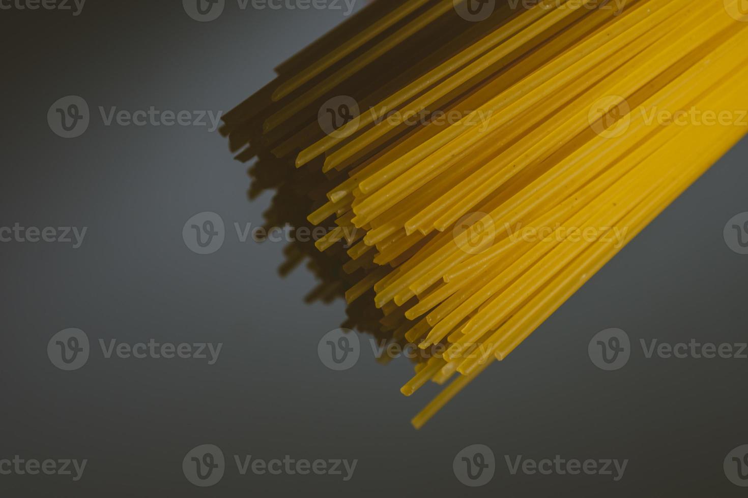 Raw pasta on a dark background photo
