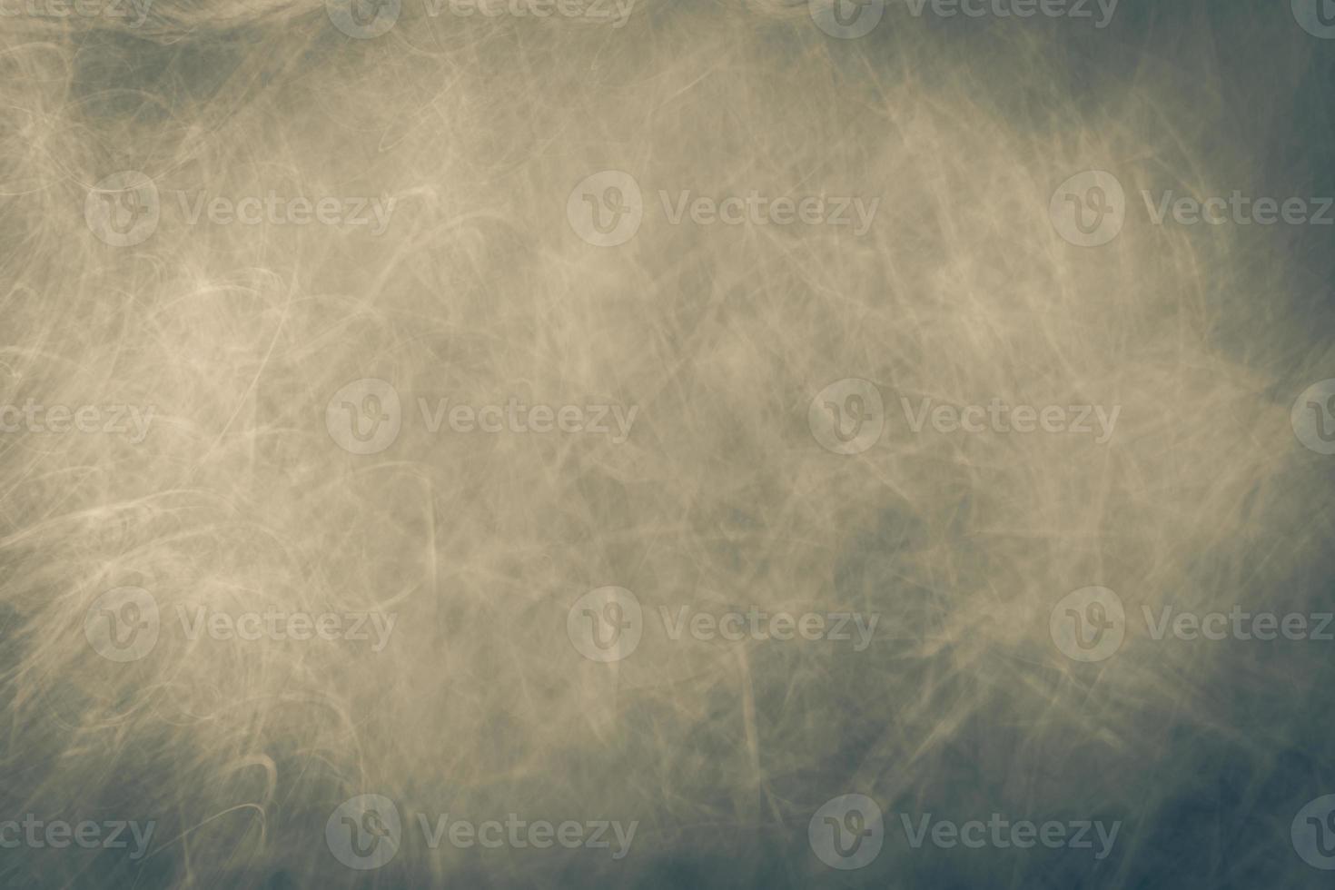 Abstract dark gray beige background with scuffs, fading, scratches and highlights. photo