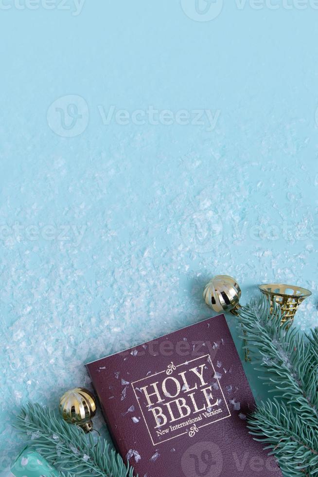 Holy bible and Christmas decor with snow. Christian winter background copy space photo