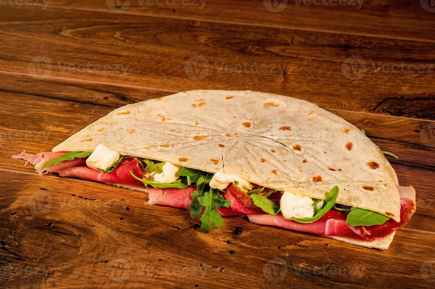 salty piadina with salami and vegetables photo