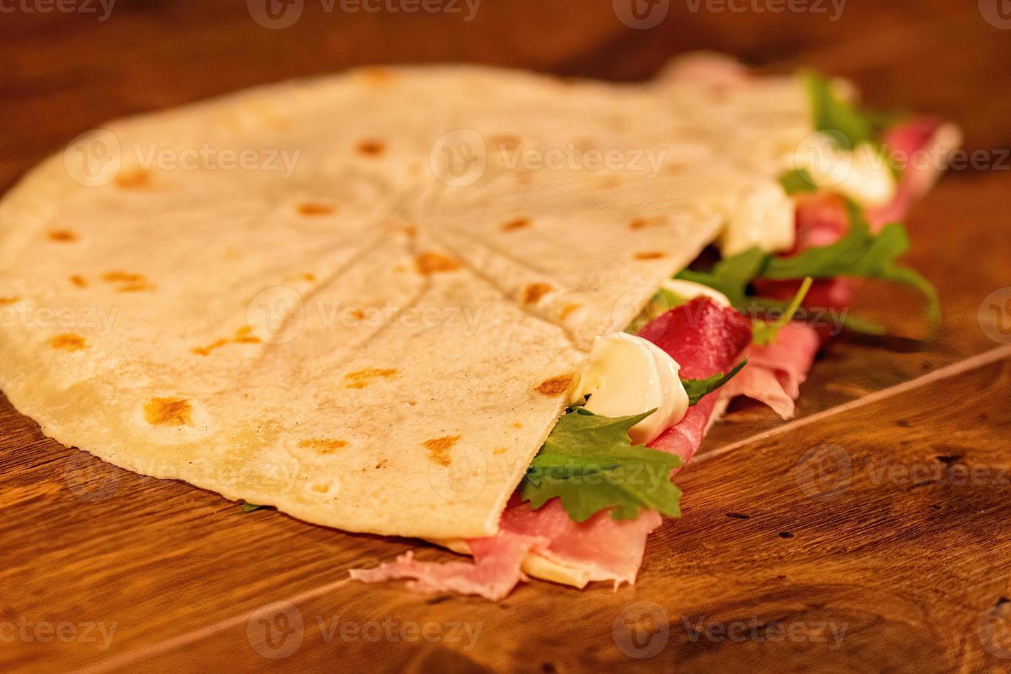 salty piadina with salami and vegetables photo