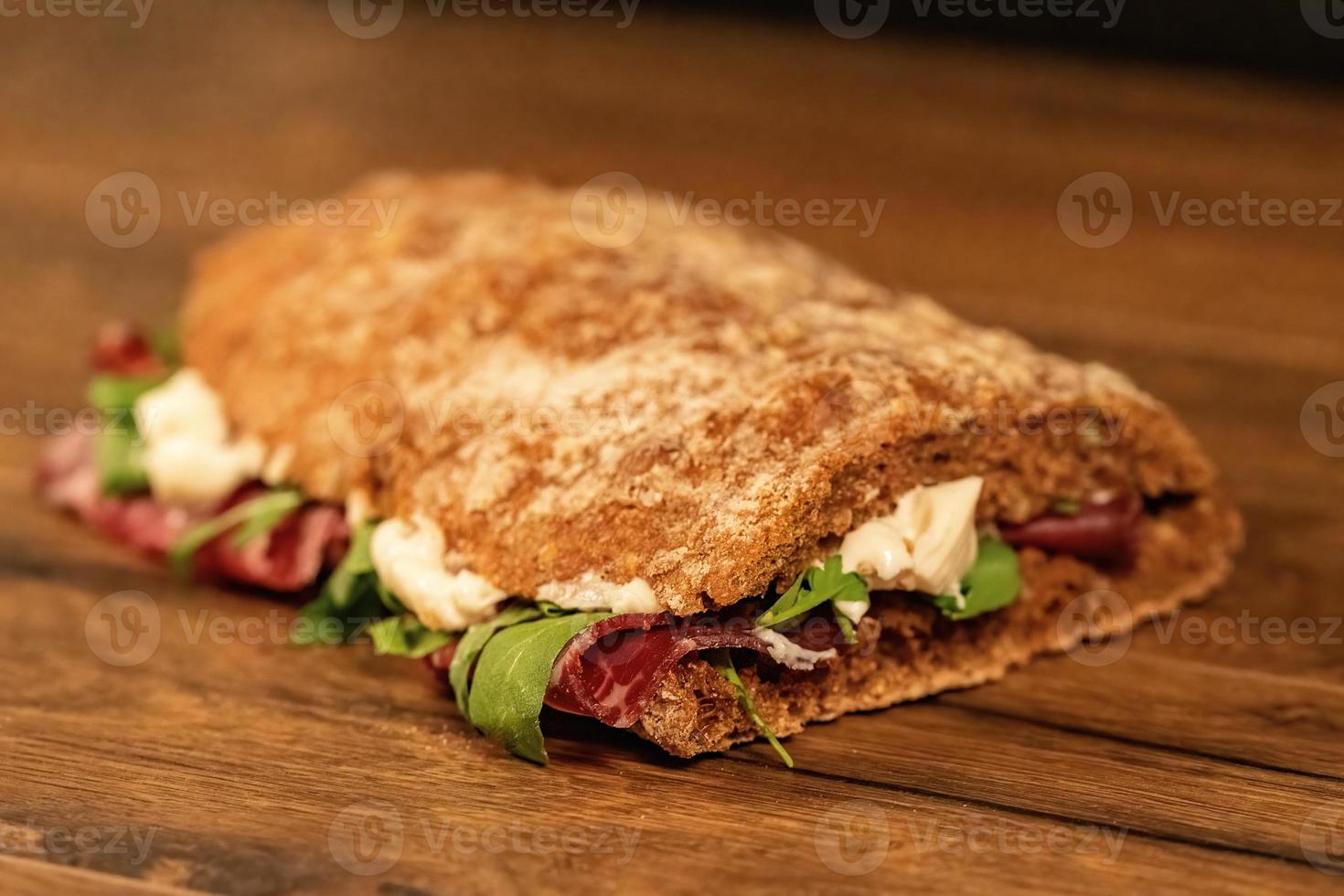 sandwich with salami and vegetables photo