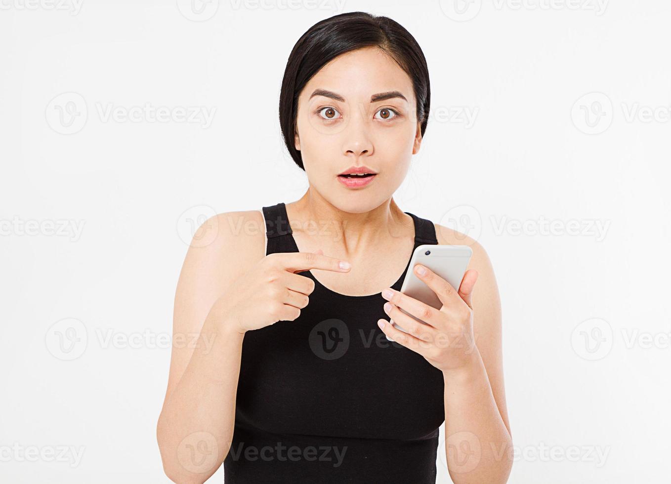 surprised, sexy asian,korean woman hold mobile phone isolated on white background, copy space photo