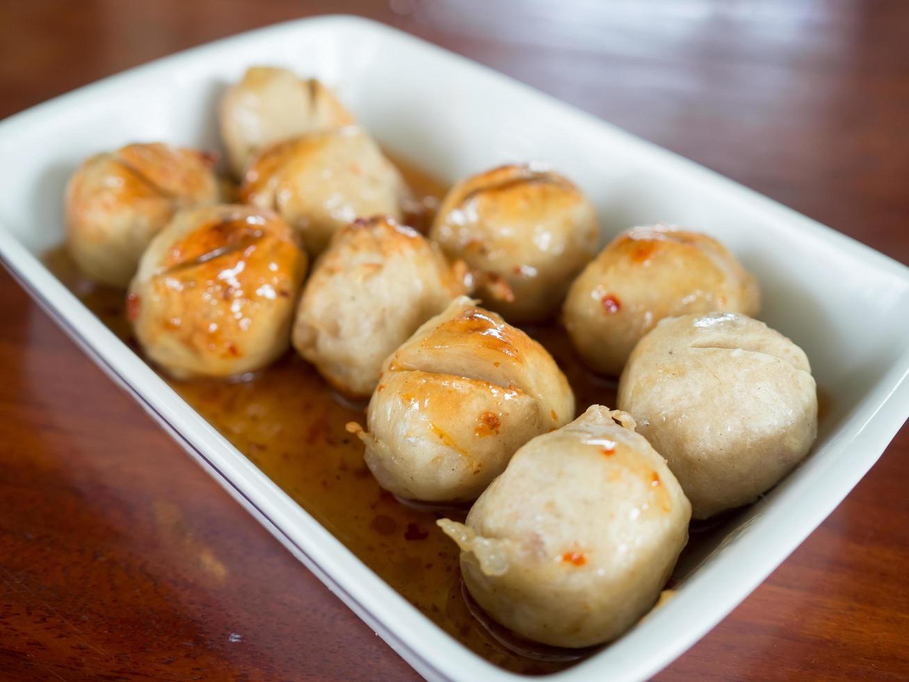 Thai meatballs on spicy and sweet sauce. photo