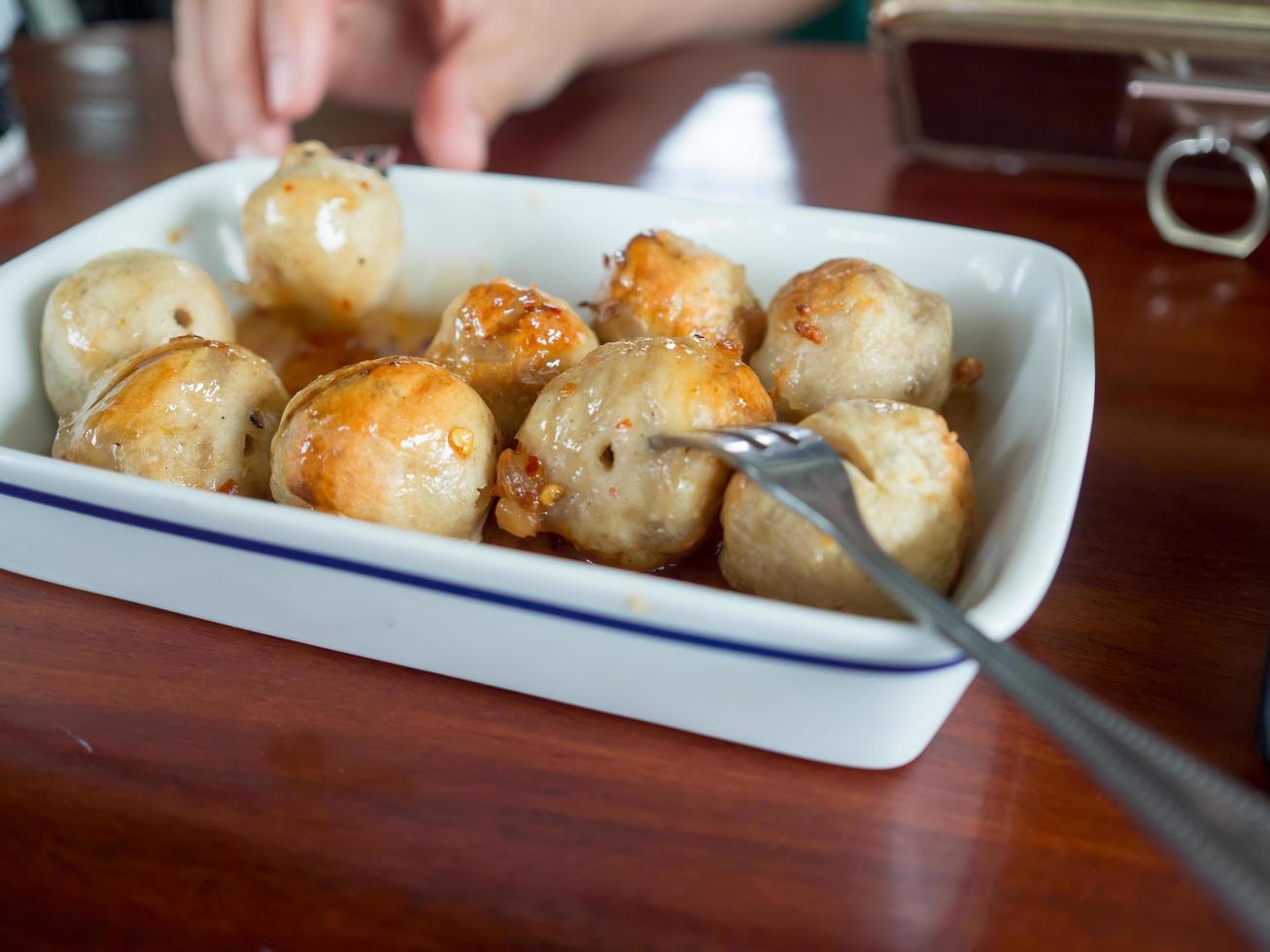 Thai meatballs on spicy and sweet sauce. photo