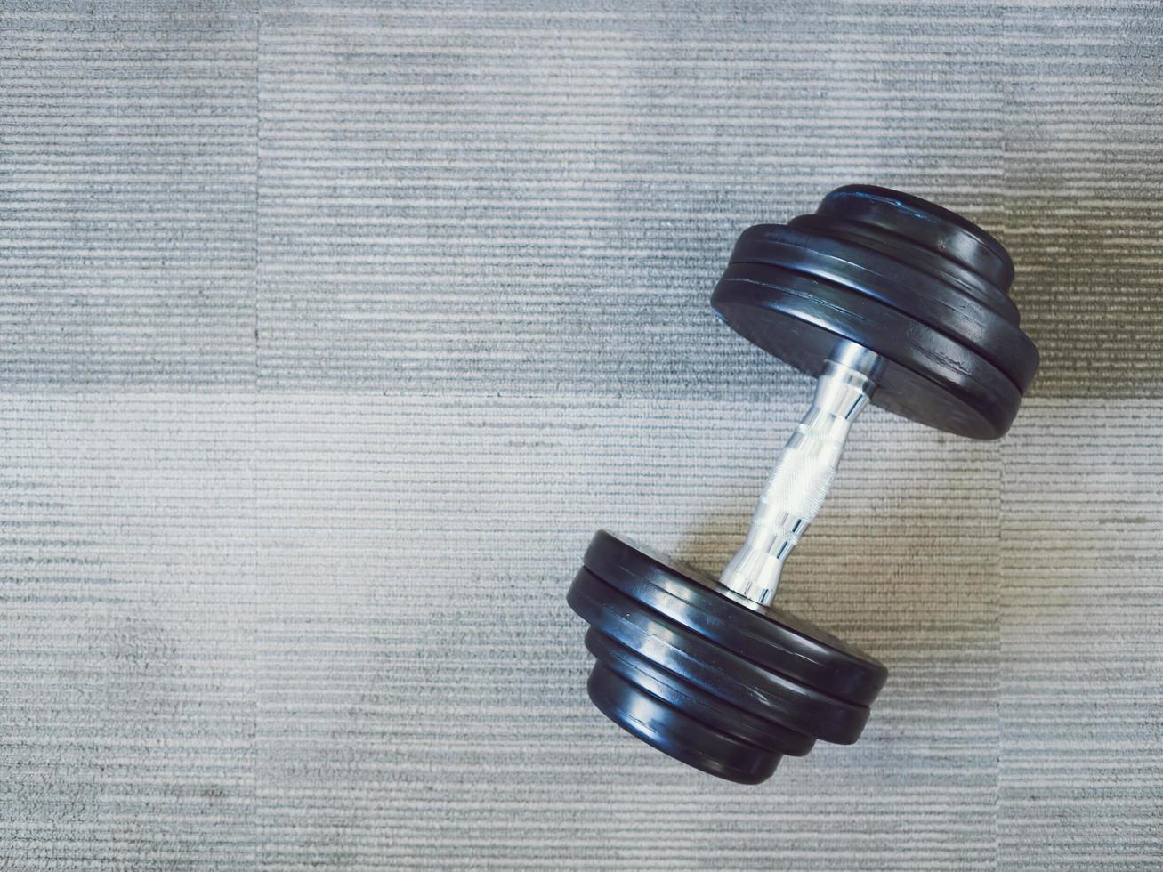 Dumbbell on the gym floor. photo