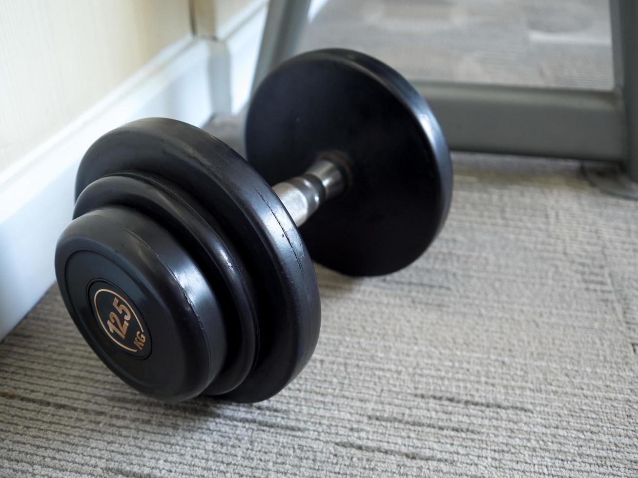 Dumbbell on the gym floor. photo