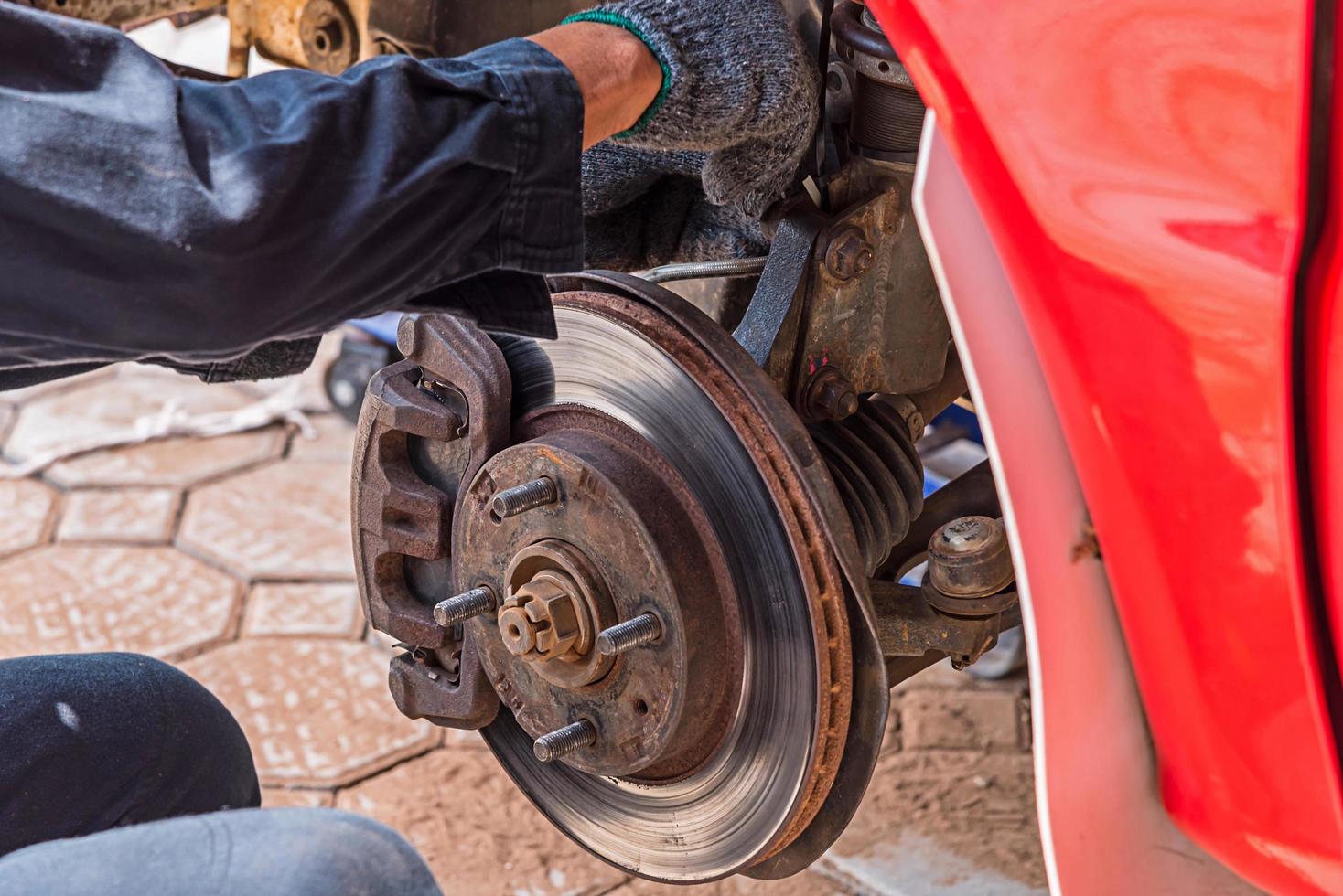 Mechanic Replacing brakes. photo
