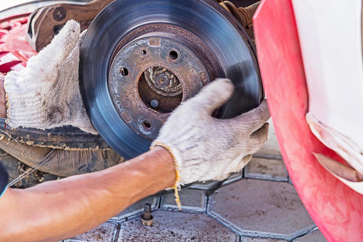 Mechanic Replacing brakes. photo